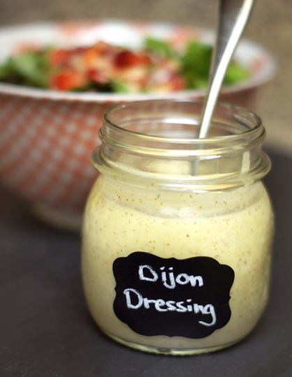 glass jar of honey dijon dressing