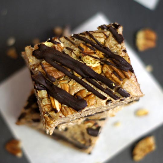 pecan bars with chocolate drizzled on top