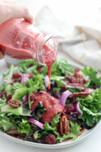 cranberry sauce dressing poured over salad