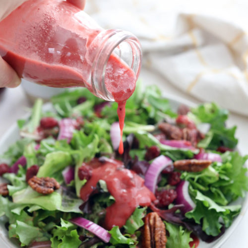 cranberry sauce dressing poured over salad