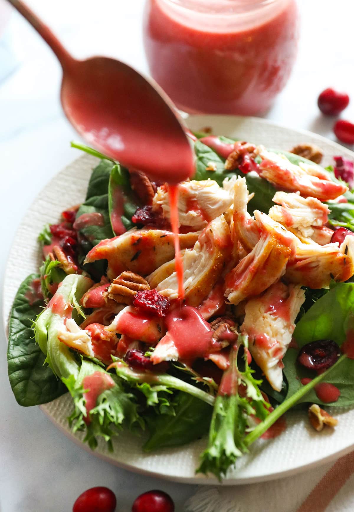 cranberry vinaigrette poured onto a salad with leftover turkey, pecans, and dried cranberries.