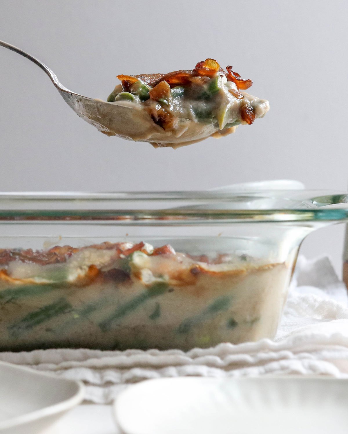 spoon lifting up healthy green bean casserole