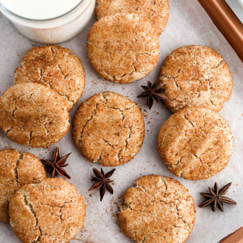 almond flour snickerdoodle cookies on baking sheet with milk