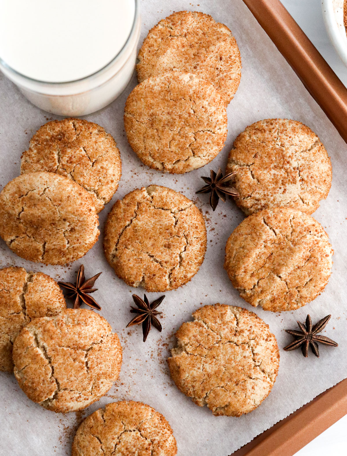 almond flour snickerdoodle cookies on baking sheet with milk