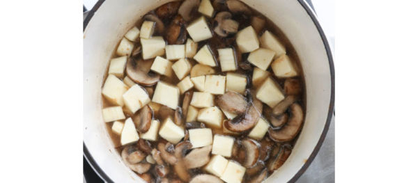 parsnips and mushrooms cooking in pot