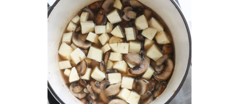 parsnips and mushrooms cooking in pot