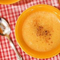 cheesy cauliflower soup in orange bowl