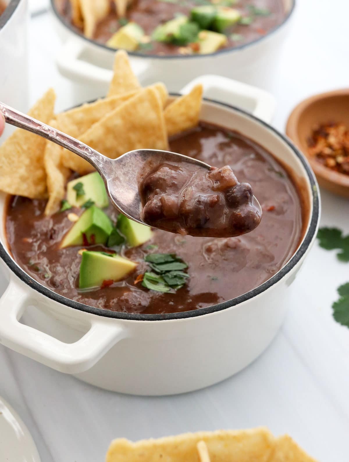 black bean soup lifted up on spoon.
