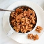 candied walnuts in a white serving bowl.