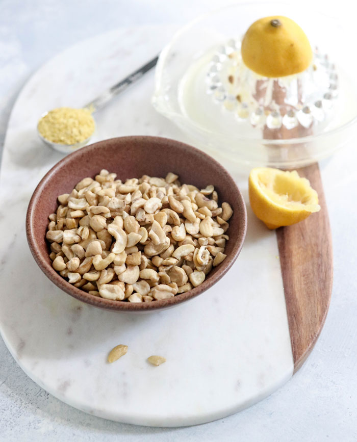bowl of cashews, nutritional yeast, and lemon juice