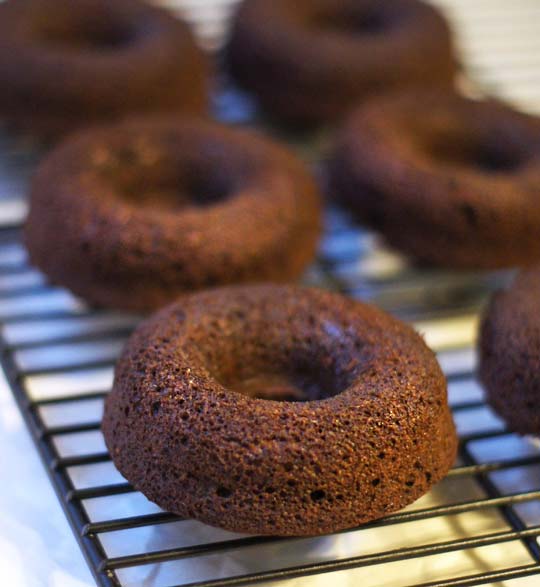 chocolate donuts on a cooling rack