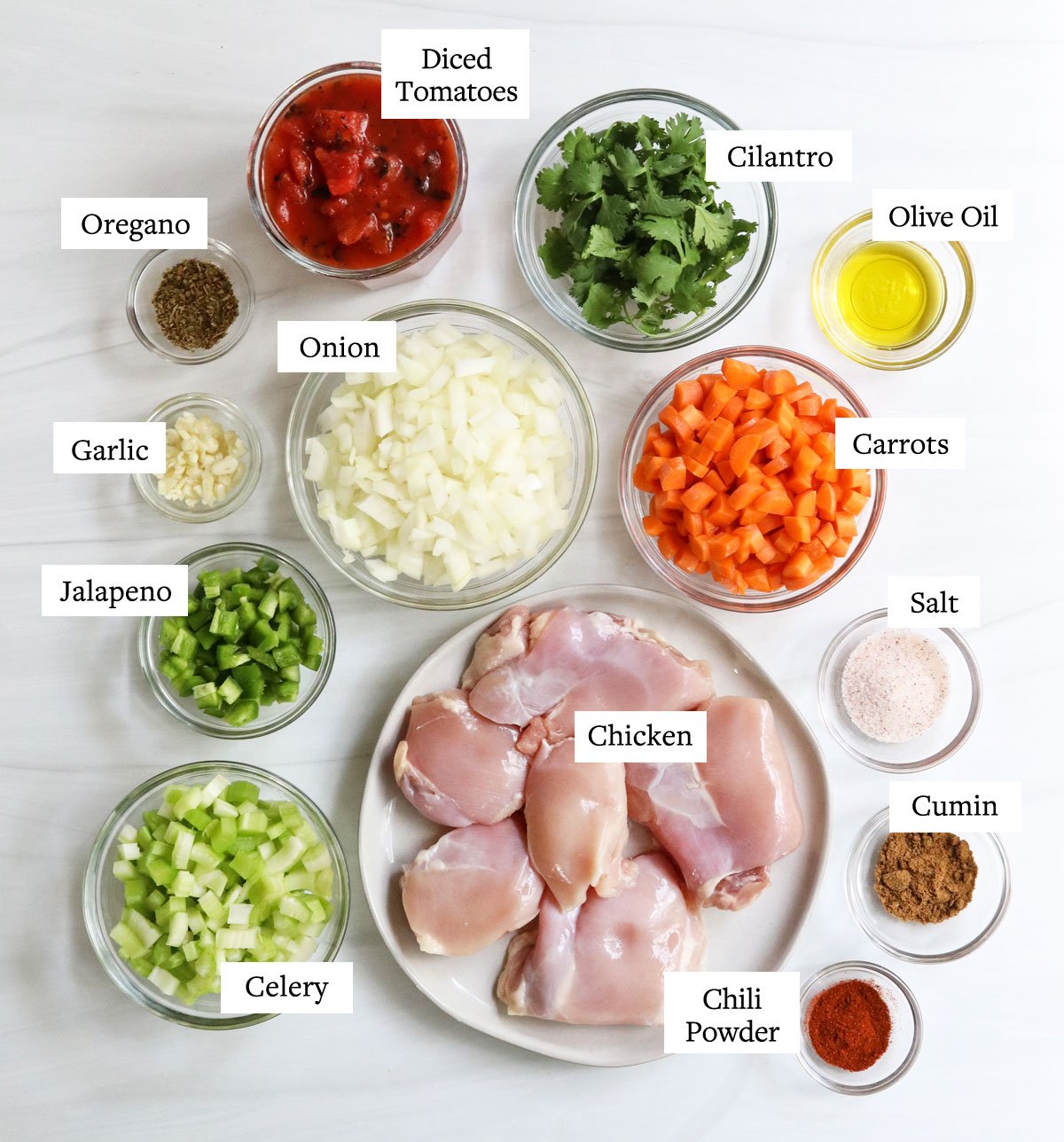 mexican chicken soup ingredients labeled on white surface.