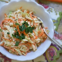 Creamy coleslaw overhead in white bowl