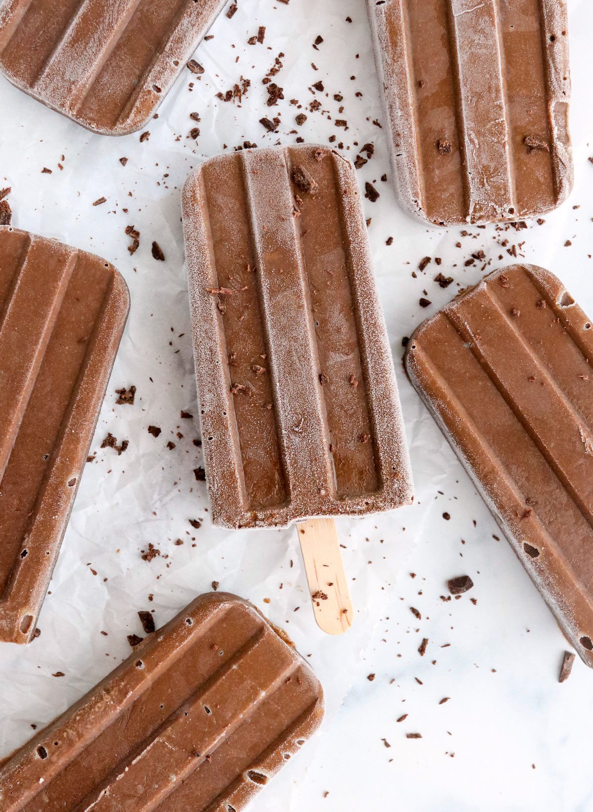 avocado fudgsicles with chocolate shavings on top