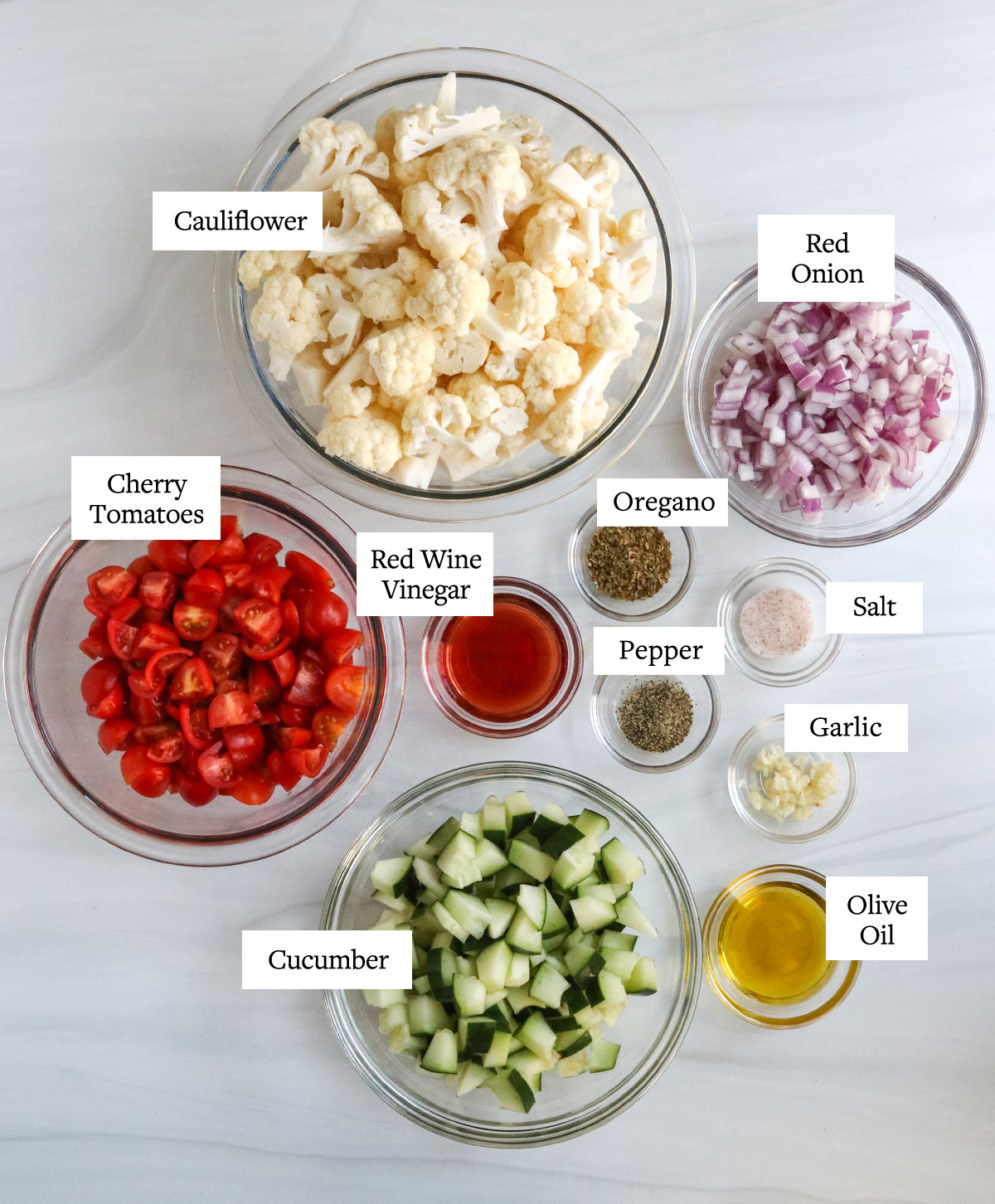 cauliflower salad ingredients in glass bowls overhead