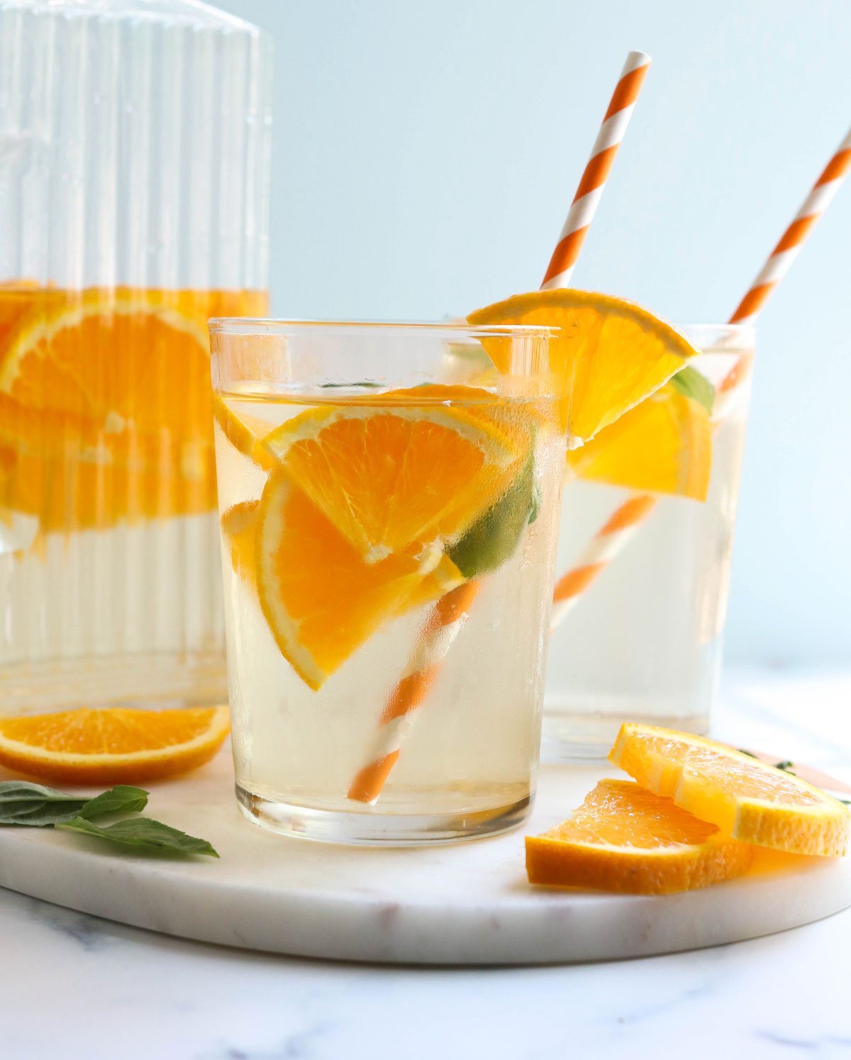 two glasses of water with orange slices