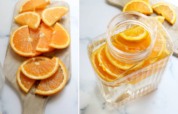 sliced oranges added to pitcher of water