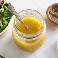 apple cider dressing with spoon in jar