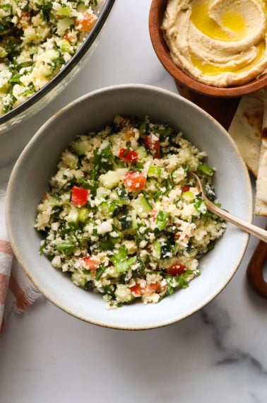 cauliflower tabbouli served in a bowl with a fork.