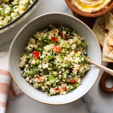 cauliflower tabbouli served in a bowl with a fork.