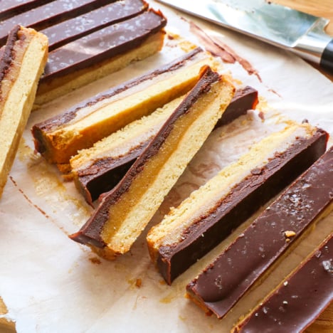 homemade twix bars sliced on a cutting board.