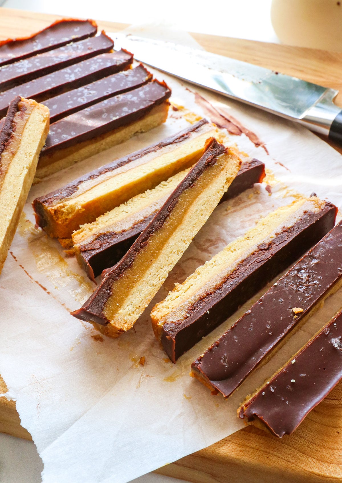 homemade twix bars sliced on a cutting board.