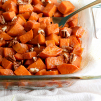 glazed sweet potatoes in dish with pecans