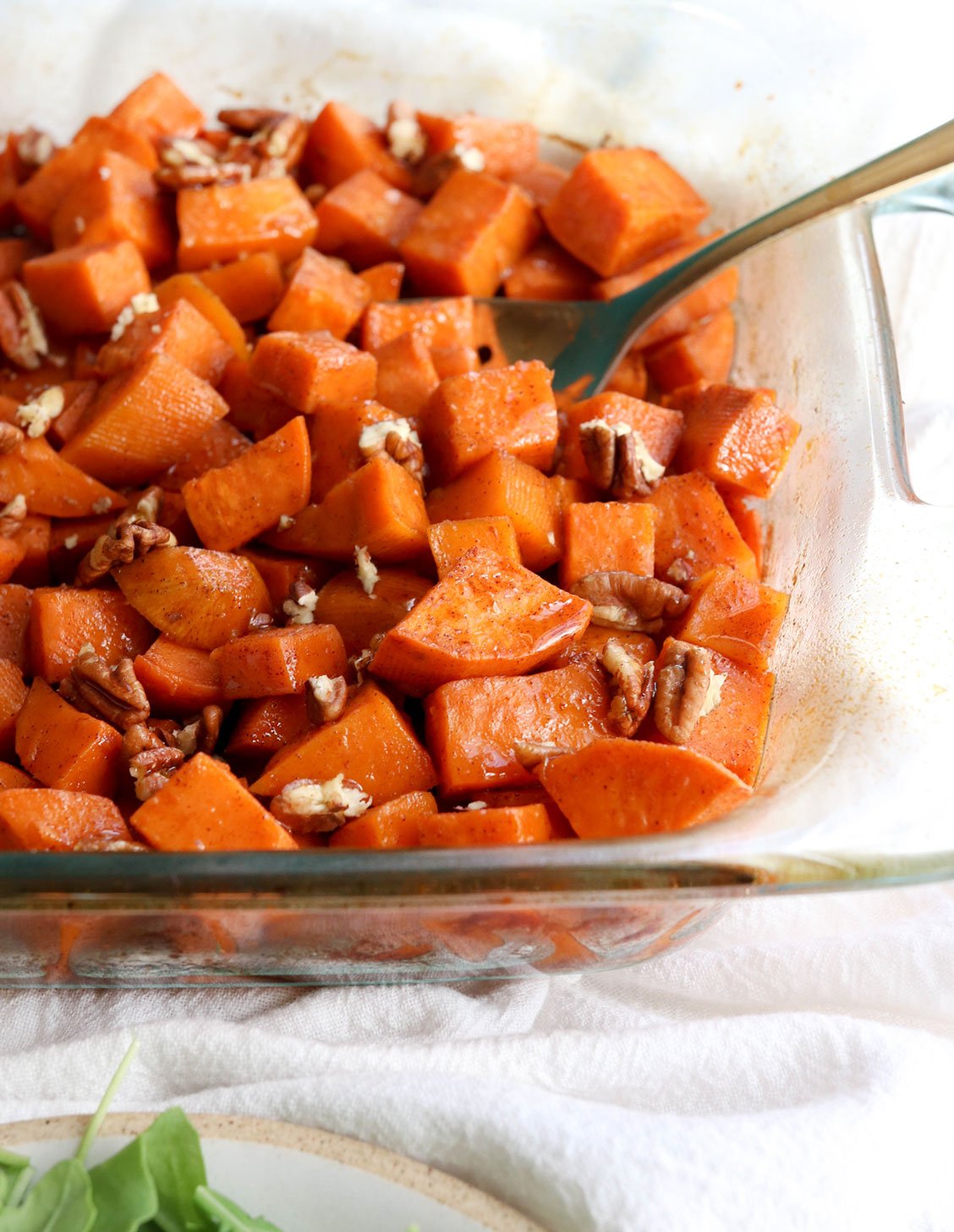 glazed sweet potatoes in dish with pecans