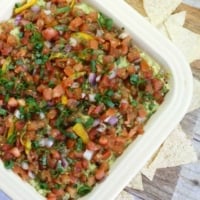 Healthy Mexican layer dip in white casserole dish