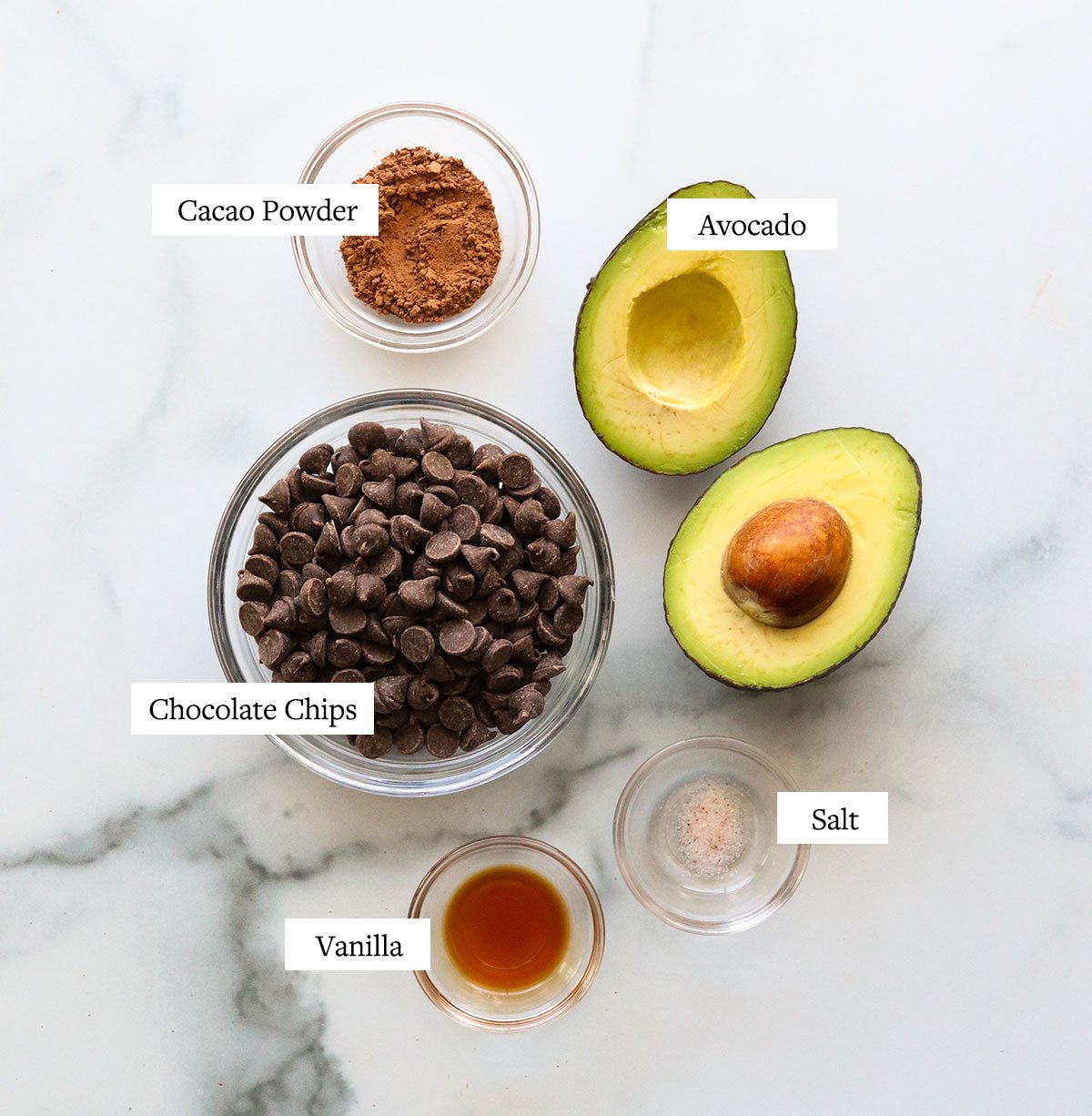 avocado truffle ingredients labeled on a marble surface.