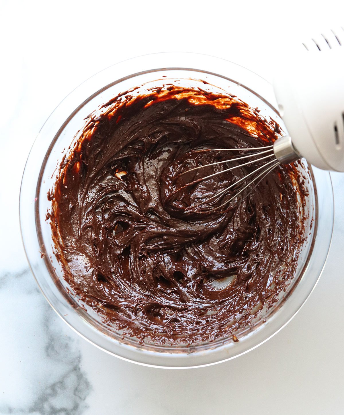 avocado mixed with melted chocolate using an electric hand mixer.