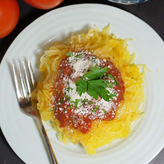 spaghetti squash on a plate with sauce on top