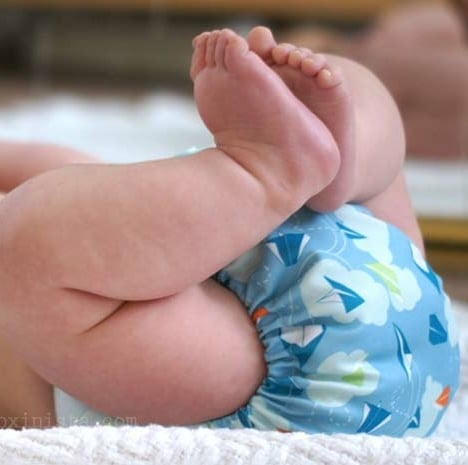 baby in reusable cloth diaper