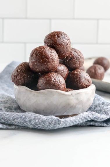 chocolate date balls in white bowl