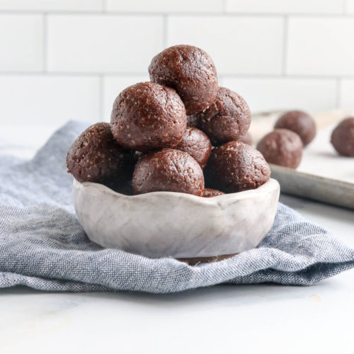 chocolate date balls in white bowl