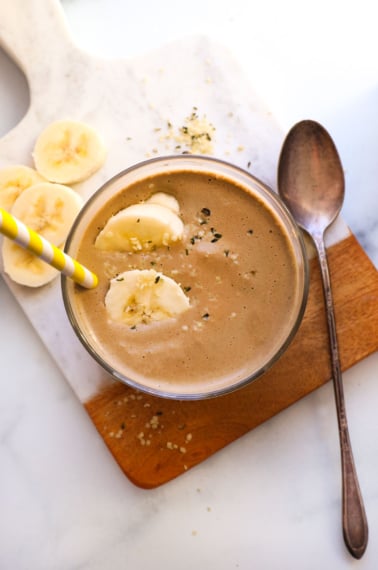 chocolate protein smoothie topped with banana slices.