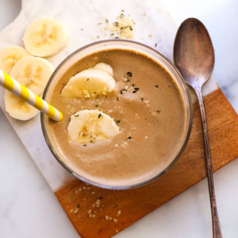 chocolate protein smoothie topped with banana slices.