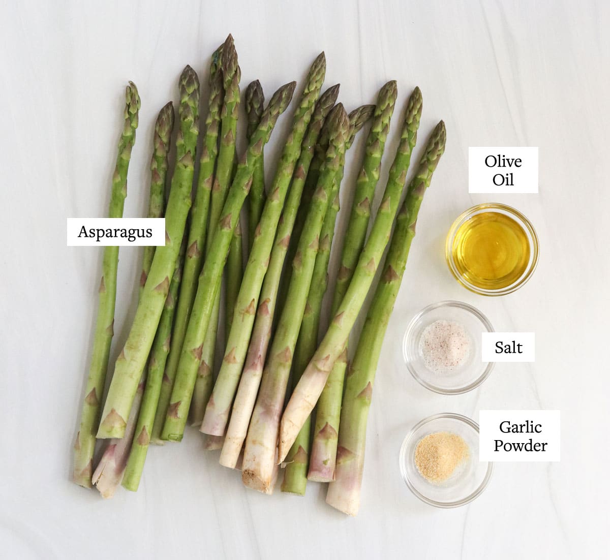 roasted asparagus ingredients on white surface.