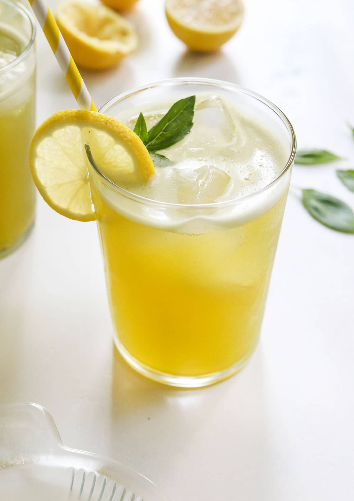 basil lemonade over ice in glass
