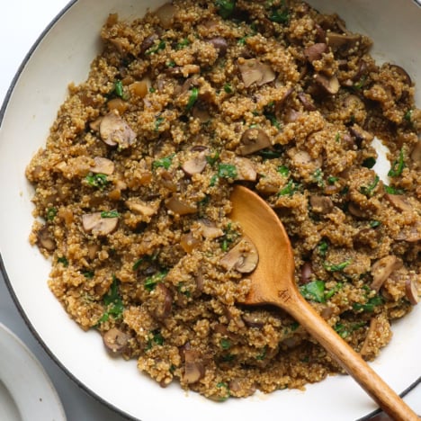 mushroom quinotto in white skillet.