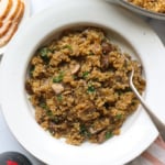 Recipe of mushroom quinoa in white bowl.