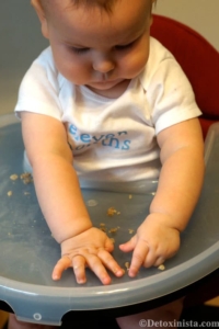 baby playing with small pieces of food