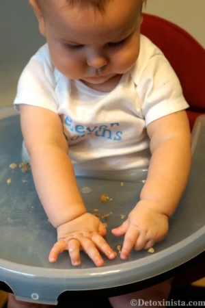 baby playing with small pieces of food