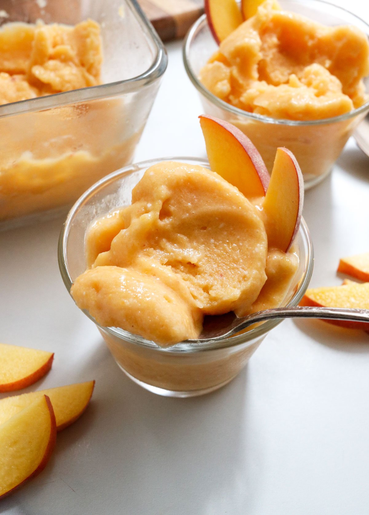 peach ice cream with spoonful removed