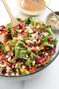 thai salad with peanut dressing in glass bowl