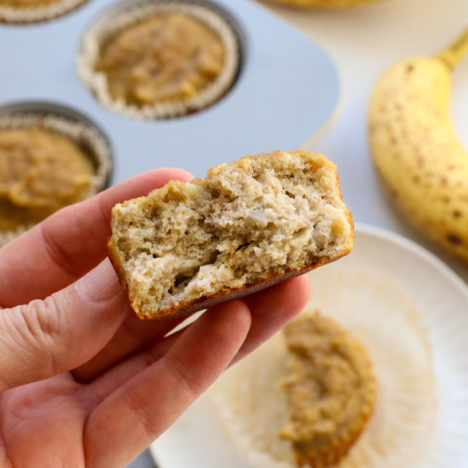 banana muffins for baby split in half and held up to show the texture.