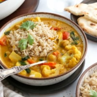 pumpkin curry served with rice and a spoon