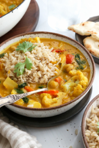 pumpkin curry served with rice and a spoon