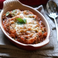 Baked vegetable marinara in red casserole dish