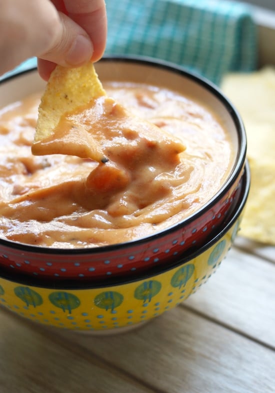 chip dipped in sweet potato queso
